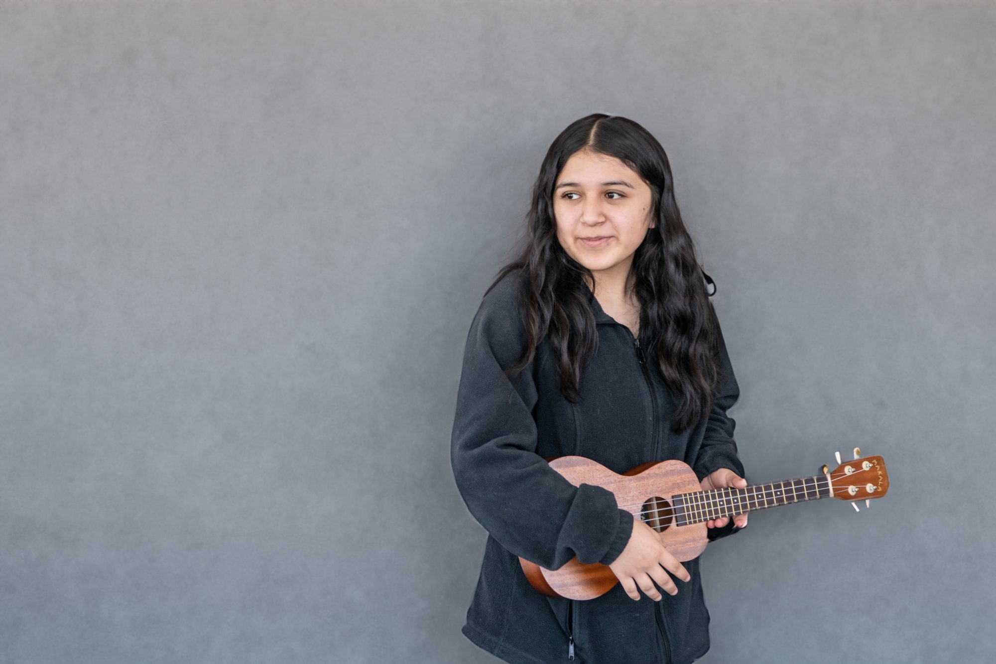 student playing ukele