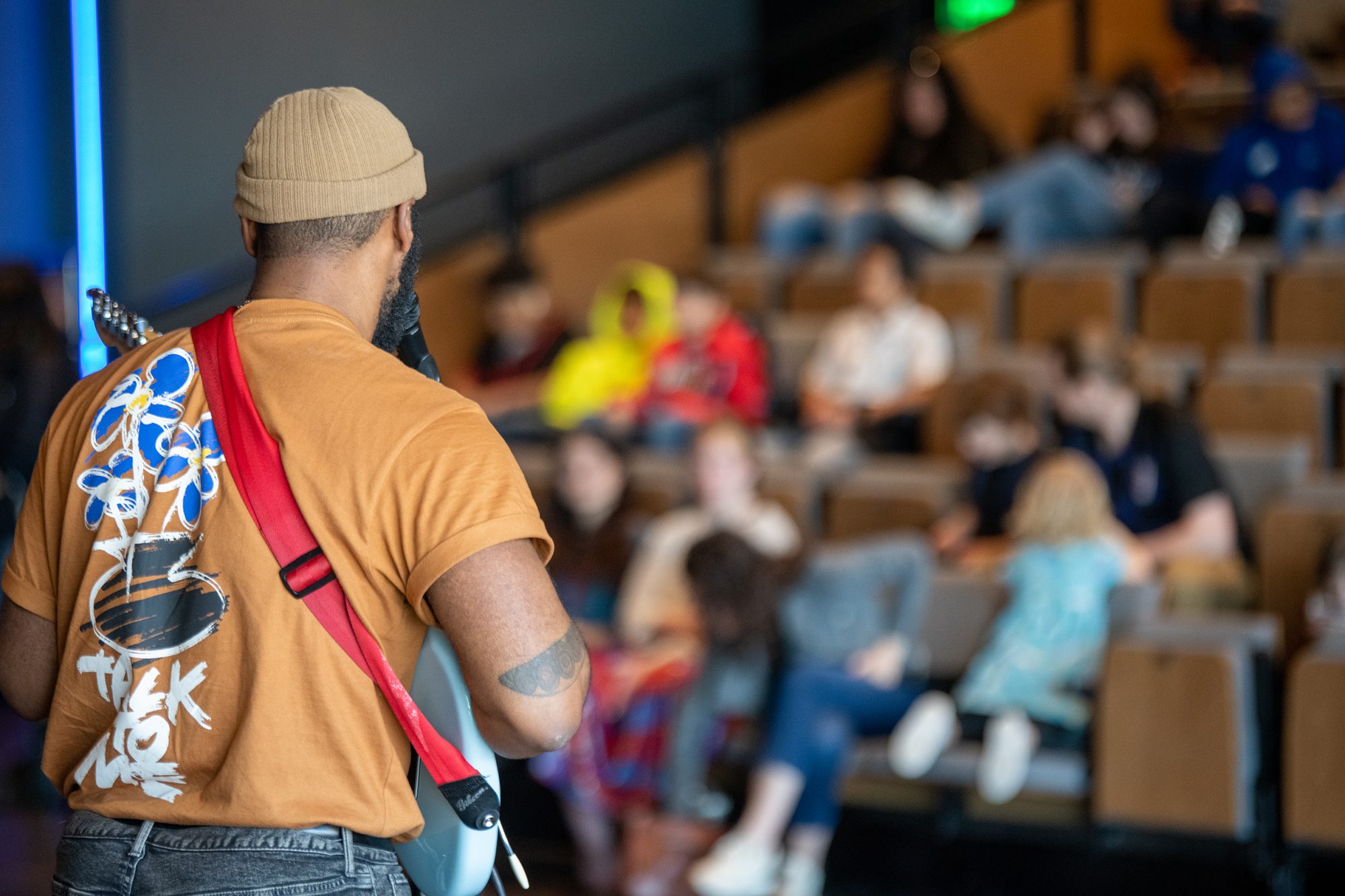 guitarist playing for students